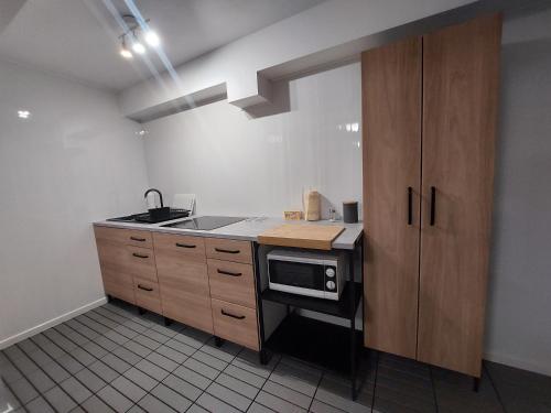 a kitchen with a sink and a stove top oven at Ludna 27 in Niechorze