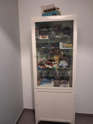 a white cabinet filled with lots of toy cars at Ludna 27 in Niechorze