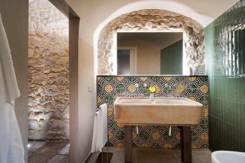 a bathroom with a sink and a mirror at Elysium Boutique Apartment - Modica in Modica