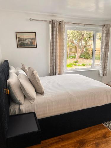 a bedroom with a large bed with a window at Shared House in Inverness in Inverness