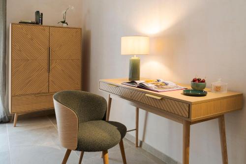 a desk with a lamp and a chair in a room at Elysium Boutique Apartment - Modica in Modica