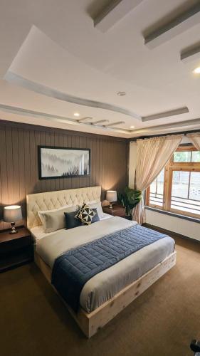 a bedroom with a large bed in a room at Soma Hotels Skardu in Skardu