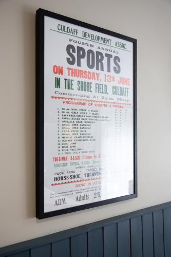 a framed poster of a concert on the wall at McGrorys in Culdaff
