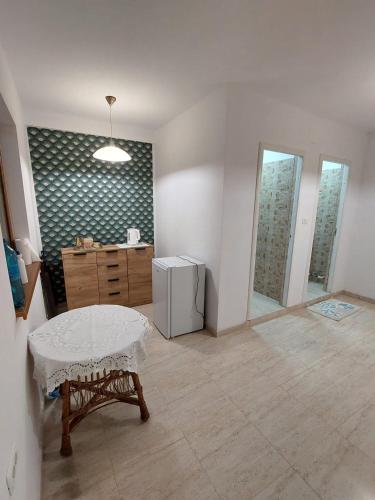 a living room with a table and a refrigerator at Casa Maria Greci in Greci