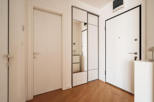 a hallway with two doors and a mirror at Vuelo Sobre by In Property in Becici