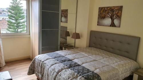 a bedroom with a bed and a large window at Funchal Apartament Marina View with PARKING FREE in Funchal