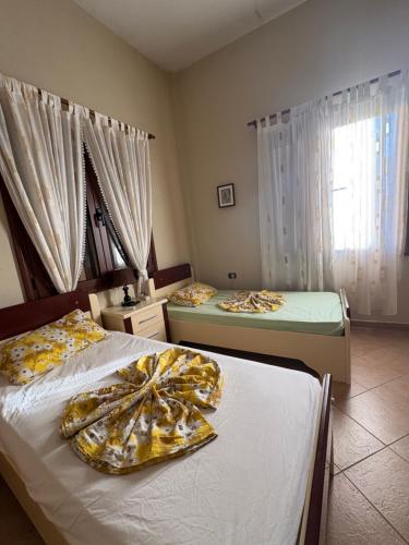 two beds in a room with two beds sidx sidx sidx at Apartament Zani in Gramsh
