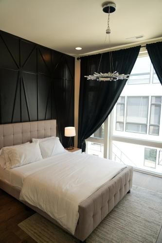 a bedroom with a large bed with a large window at Nashville Riverfront Bliss in Nashville
