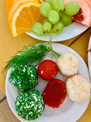 two plates of food with fruit on a table at Dom Wczasowy Nad Lubaczowką in Radawa