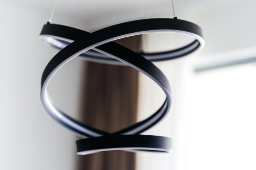 a pair of black rings hanging on a wall at Vuelo Sobre by In Property in Becici