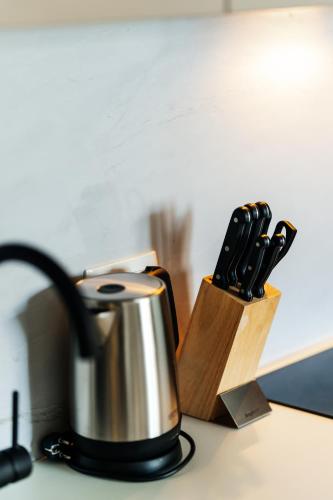 a tea kettle and a knife block on a counter at Vuelo Sobre by In Property in Becici