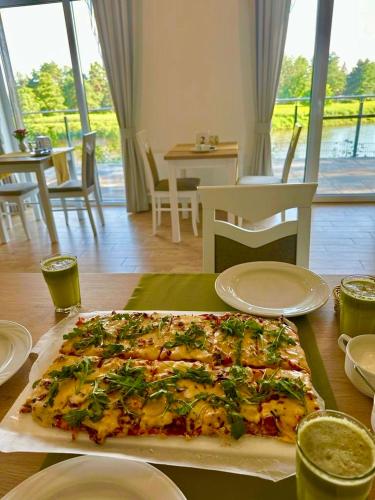 a large pizza sitting on top of a table at Dom Wczasowy Nad Lubaczowką in Radawa