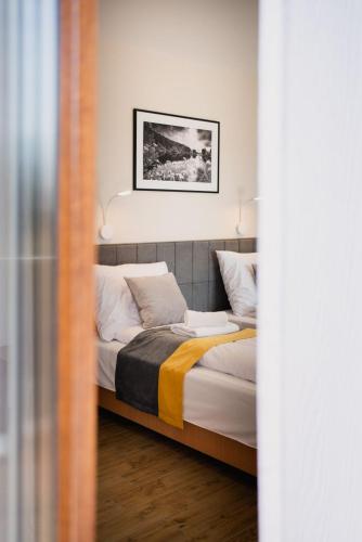 a bedroom with two beds and a picture on the wall at Dom Wczasowy Nad Lubaczowką in Radawa