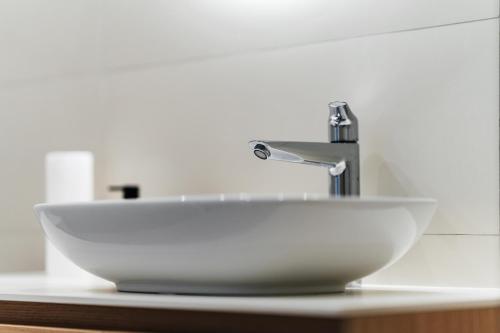a bathroom sink with a faucet on a counter at Vuelo Sobre by In Property in Becici