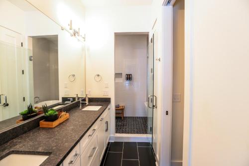 a bathroom with two sinks and a shower at Nashville Riverfront Bliss in Nashville