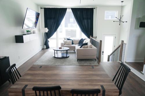 a living room with a couch and a table at Nashville Riverfront Bliss in Nashville