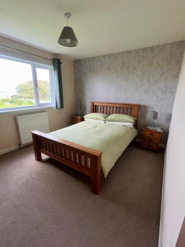 a bedroom with a large bed and a window at Nortaing orkney in Orkney