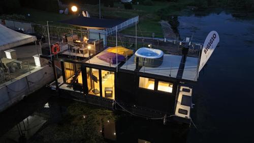 a boat is docked in the water at night at DIAMOND Bigigio House Boat in Lisanza