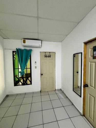 an empty room with a door and a window at LA CASONA SV Hostal in La Libertad
