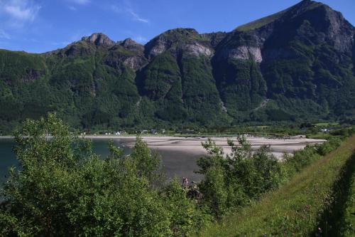 a mountain view of a beach with water and trees at Storviksanden Camping in Storvik