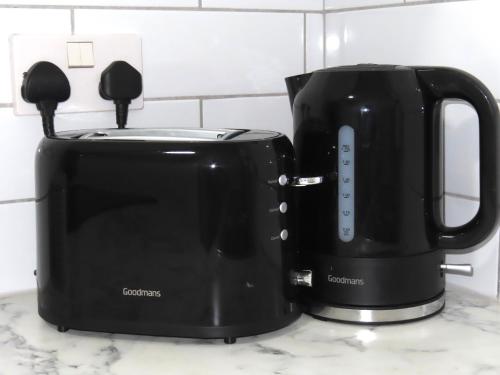 a black toaster sitting on top of a counter at 6 Mins to NEC & BHX Apartment with FREE Parking in Sheldon
