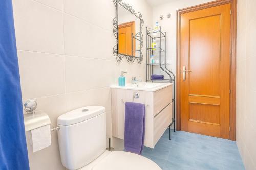 Un baño con inodoro, lavabo y espejo. en Central Park-Coastal Refuge by the Beach, en Estepona