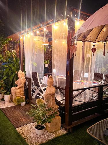 a patio with a table and chairs and lights at ORHO Hotel Boutique 15 minuts PTY Airport free shuttle in Tocumen