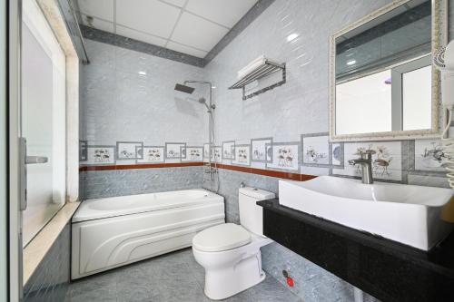 a bathroom with a toilet and a sink and a tub at Victory Hotel in Ho Chi Minh City