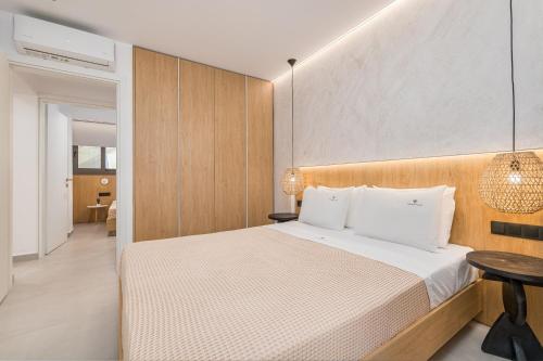 a bedroom with a bed and a table at Dionisos Luxury Villas in Pefkohori