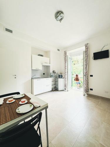 a living room with a table and a kitchen at Emilio House in Levanto