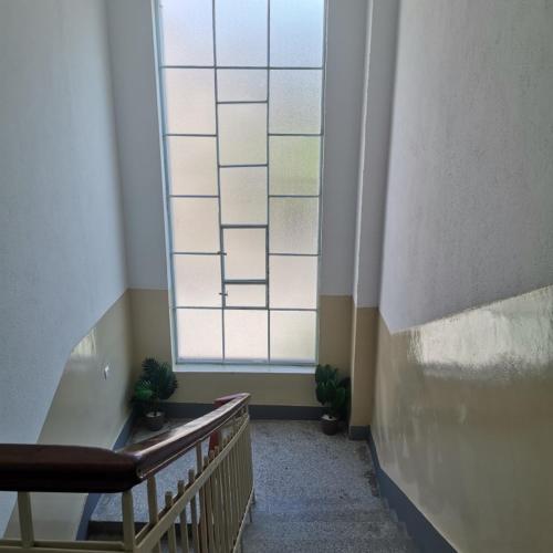 a hallway with a large window in a building at Zenith Apartment in Bitola