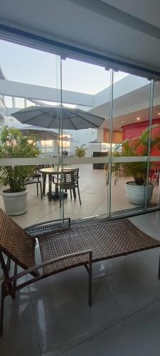 a building with a patio with tables and benches at Hotel Atlântico Tower in Rio de Janeiro