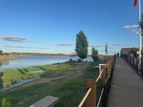a wooden walkway next to a body of water at Casa Sítio do Vale, Alandroal in Alandroal