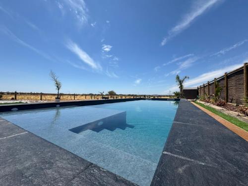 a swimming pool in the middle of a yard at Casa Sítio do Vale, Alandroal in Alandroal