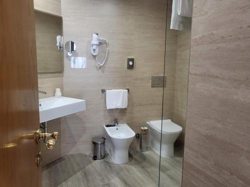 a bathroom with a toilet and a sink and a shower at Alli Due Buoi Rossi in Alessandria