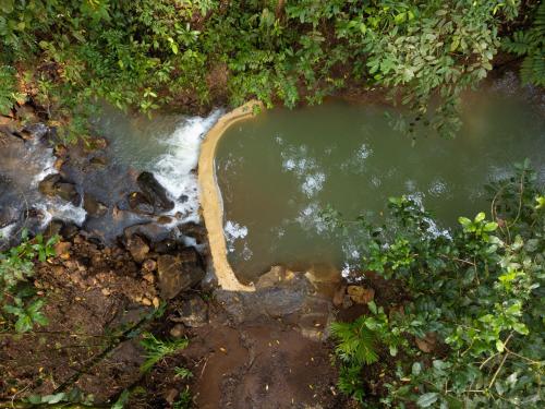 an aerial view of a pool of water in a creek at Hotel Heliconias Nature Inn & Hot Springs in Fortuna