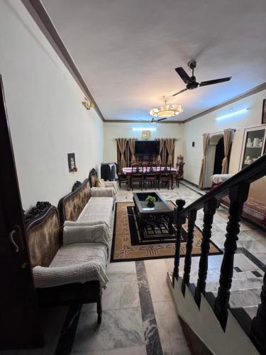 a living room with a couch and a table at NAS VILLA in Mysore
