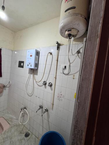 a bathroom with two shower heads and a toilet at NAS VILLA in Mysore