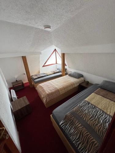a room with two beds and a window at Motel MOSKVA in Bijelo Polje
