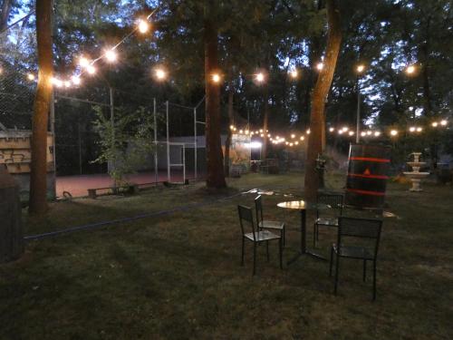 a park at night with lights and a table and chairs at Hotel Rural Camino Medulas in Ponferrada