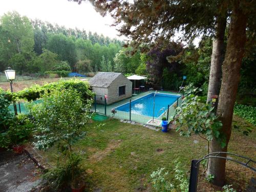 an image of a swimming pool in a yard at Hotel Rural Camino Medulas in Ponferrada