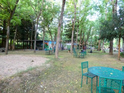 a blue table and chairs in a park with trees at Hotel Rural Camino Medulas in Ponferrada