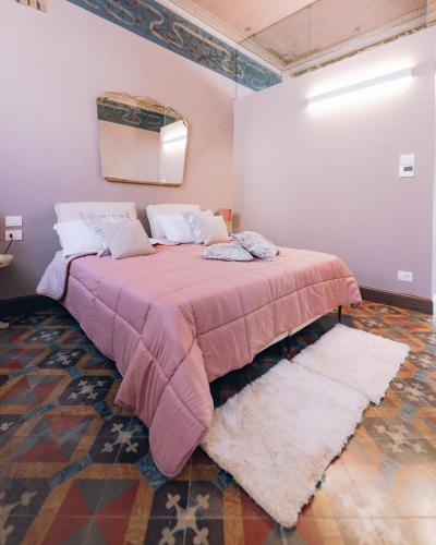 a bedroom with a large bed in a room at Palazzo Isabella residenza storica in Borgo San Giacomo in Borgo San Giacomo