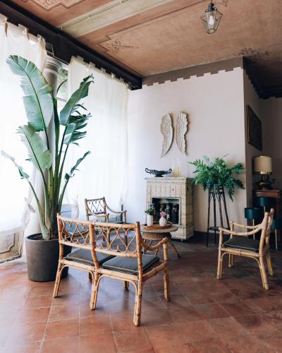 a living room with two chairs and a fireplace at Palazzo Isabella residenza storica in Borgo San Giacomo in Borgo San Giacomo