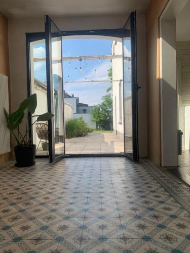 an open door to a hallway with a tile floor at De parel van TOMORROWLAND in Niel
