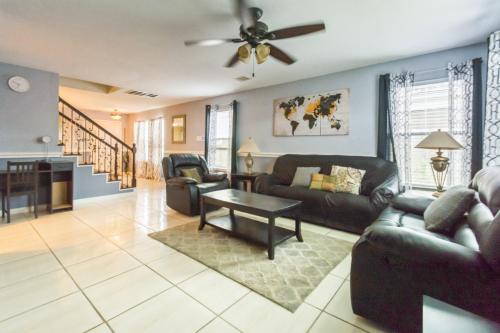a living room with a couch and a table at Lux Comfy Home Mins To NW Med Hospital Airport! in Houston