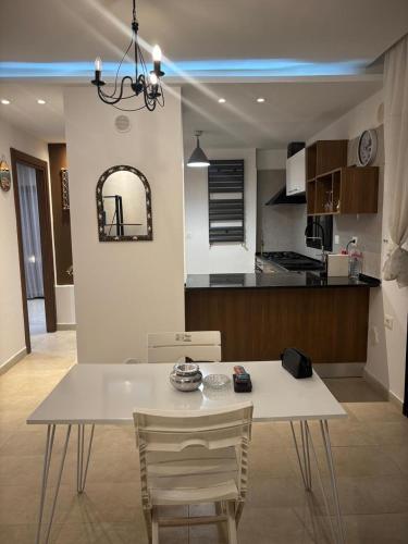 a white dining table and chairs in a kitchen at Le Majorelle in La Marsa