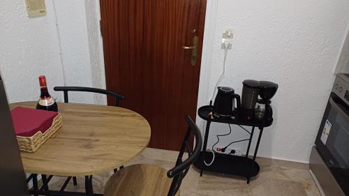 a table and chairs with a bottle of wine on it at Viola Elounda Apartament in Skhísma