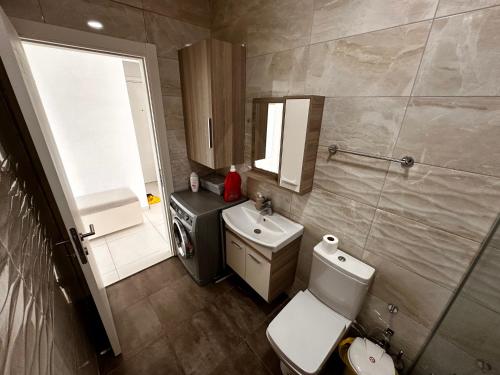 a bathroom with a white toilet and a sink at Kyrenia Central Kaşkar region 2 bedroom residence in Prodhromi