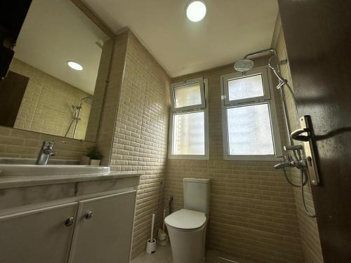 a bathroom with a toilet and a sink and a mirror at Cabo House in Cabo Negro